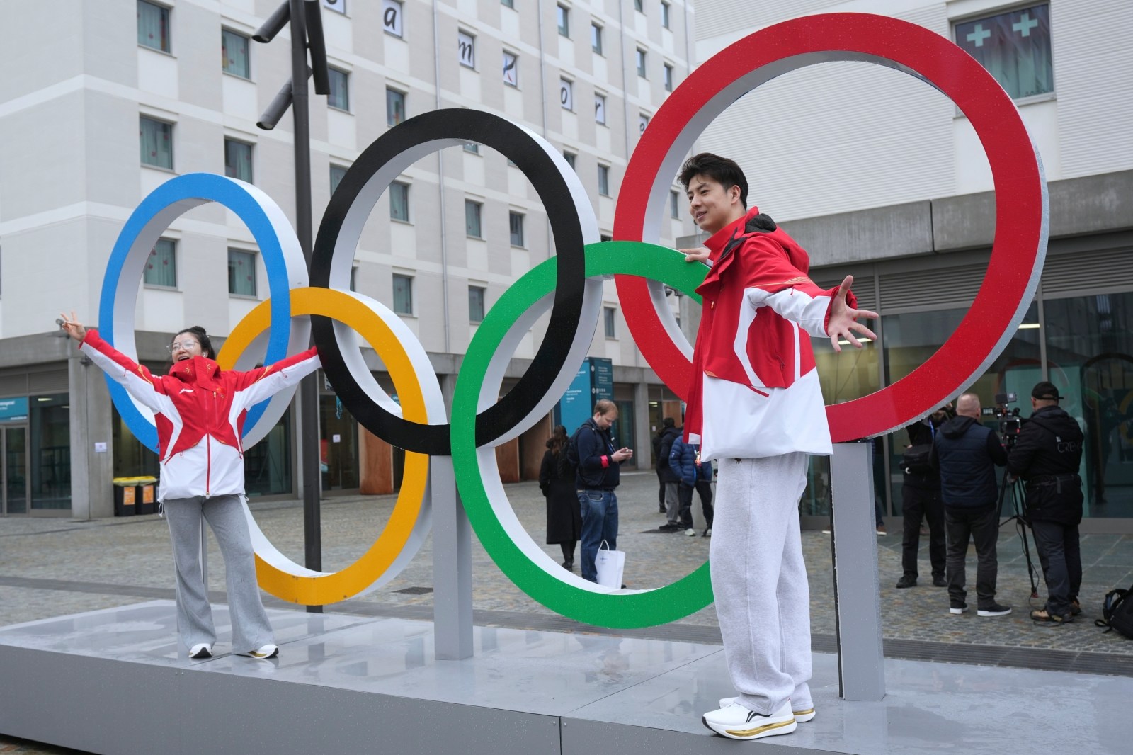 Chinese figure skaters Liu Xinyu and Wang Shiyue pose with the Olympic rings inside the Olympic Village ahead of the 2026 Winter Olympics, in Milan, Italy on February 3, 2026.
