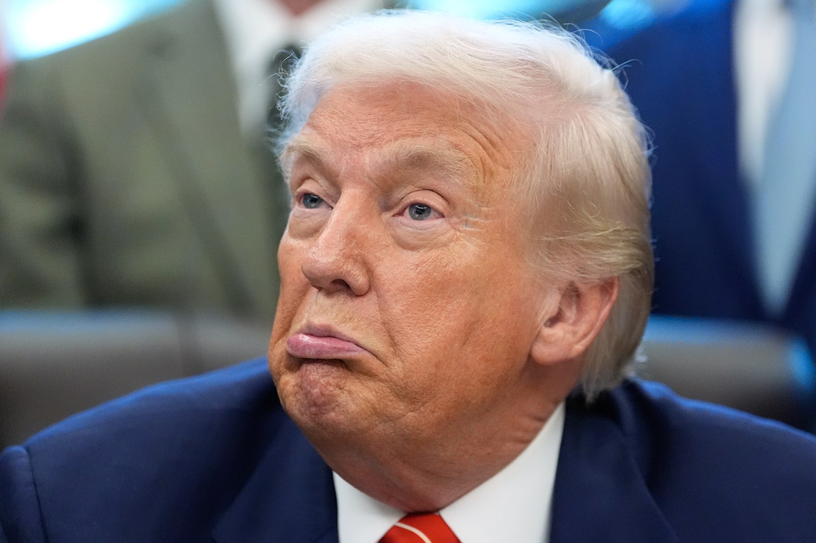 President Donald Trump reacts as he speaks to reporters after signing a spending bill that ends a partial shutdown of the federal government in the Oval Office of the White House, Tuesday, Feb. 3, 2026, in Washington. (AP Photo/Alex Brandon)
