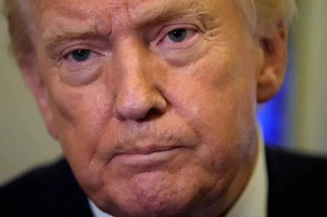 President Donald Trump listens to a reporter's question as he flies aboard Air Force One from Joint Base Andrews, Md., to West Palm Beach, Fla., Friday, Feb. 6, 2026