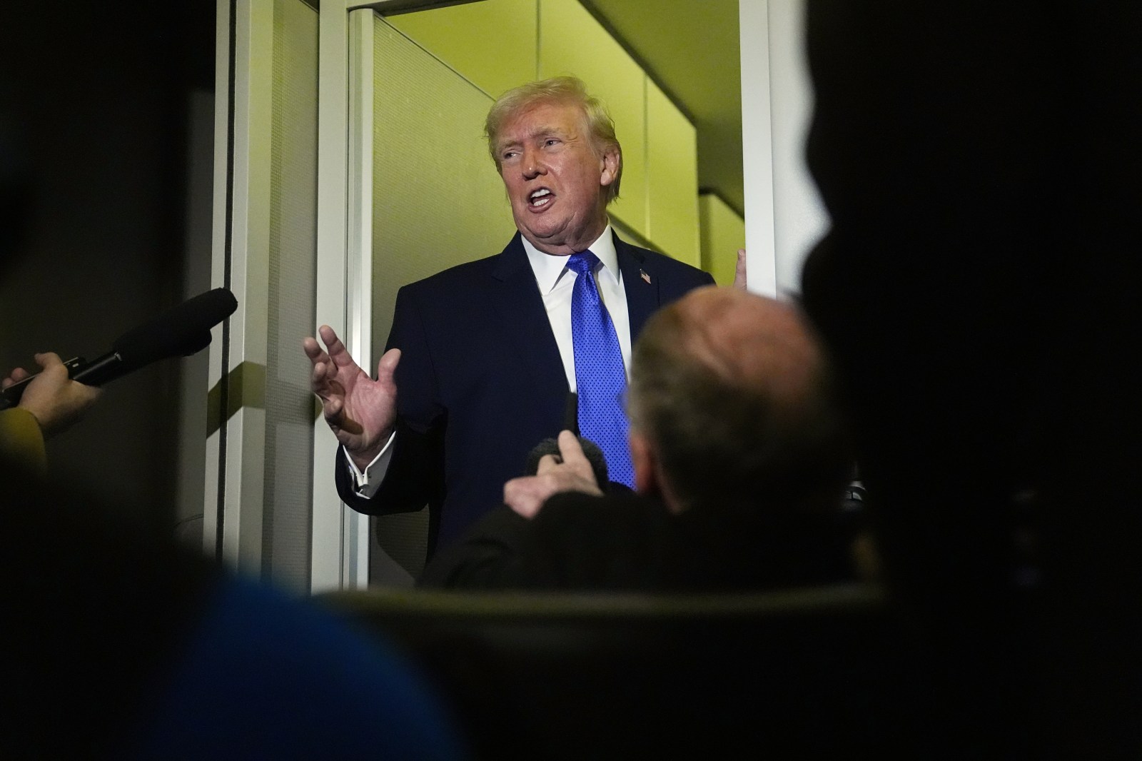 President Donald Trump speaks with reporters aboard Air Force One, Monday, Feb. 16, 2026, en route to Washington from West Palm Beach, Fla. (AP Photo/Matt Rourke)