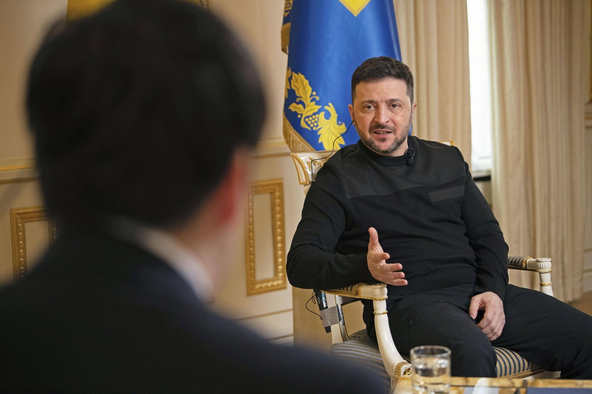 Ukrainian President Volodymyr Zelenskyy (back) speaks during an interview in Kyiv on Feb. 19, 2026.