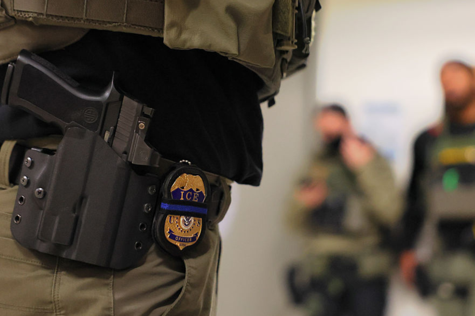 : An ICE officers badge is seen as federal agents patrol the halls of immigration court at the Jacob K. Javits Federal Building on June 10, 2025 in New York City.