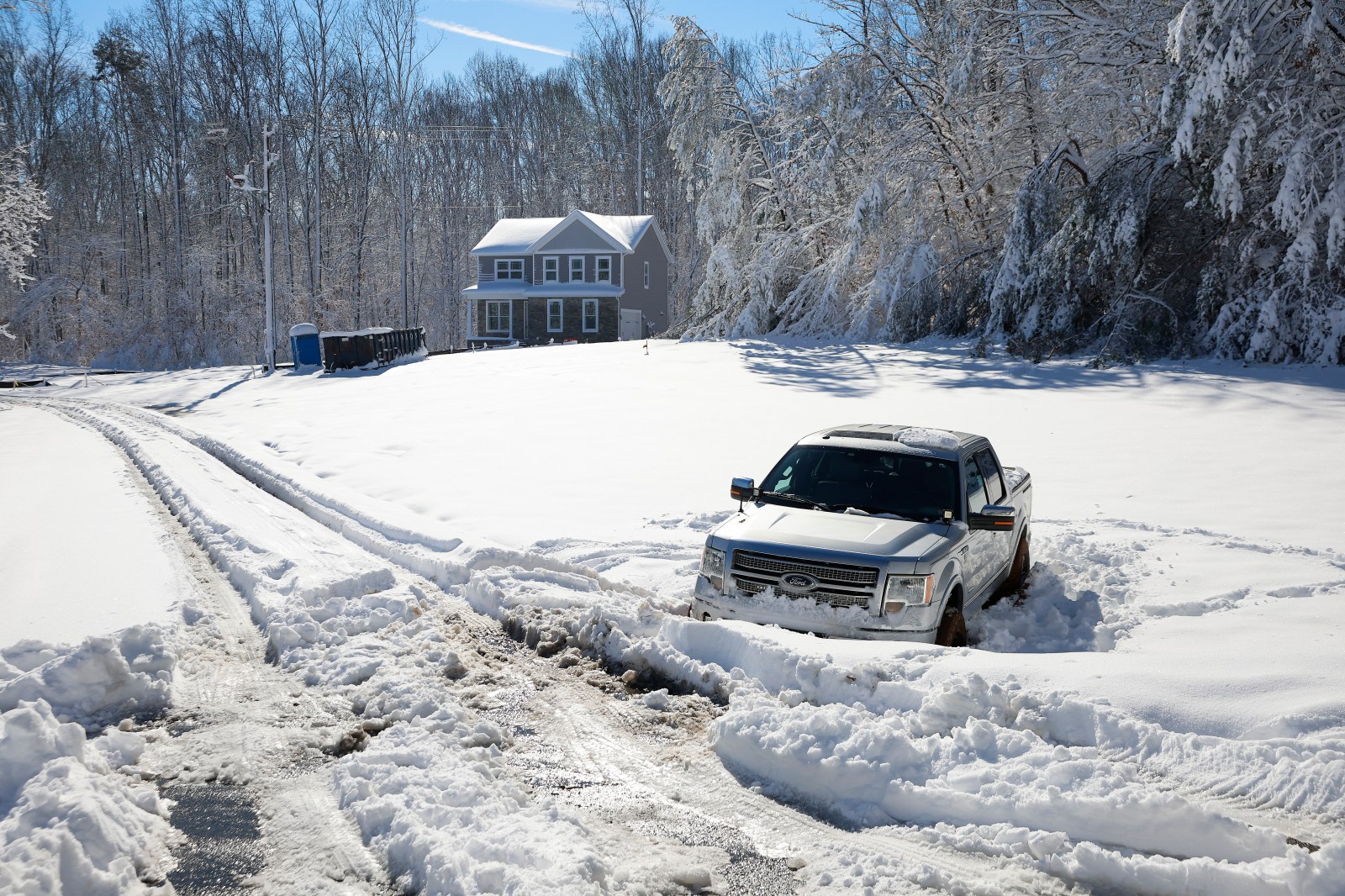 File Photo: A pickup truck sits abandoned after sliding off the road in icy conditions in Stafford County, Virginia, on January 04, 2022. 
