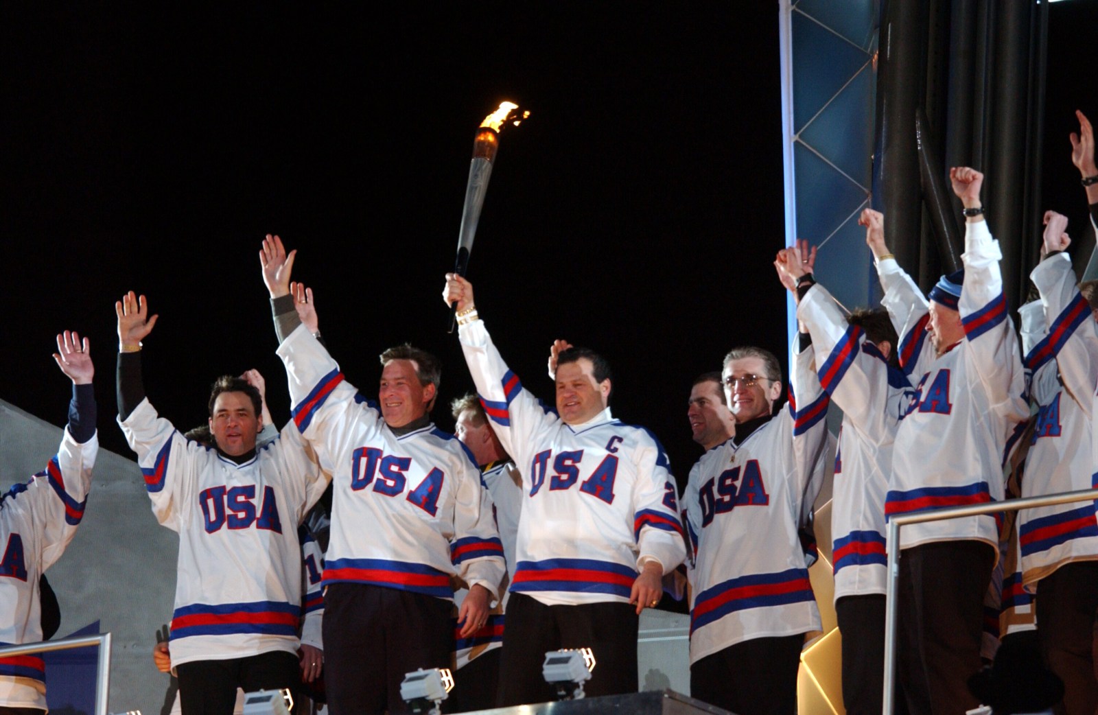 8 Feb 2002:  Captain Mike Eruzione and other members of the 1980 gold medal-winning USA men’s hockey team hold up the torch before lighting the Olympic flame at the Opening Ceremony of the Salt Lake City Winter Olympic Games at the Rice-Eccles Olympic Stadium in Salt Lake City, Utah. DIGITAL IMAGE. Mandatory Credit: Doug Pensinger/Getty Images