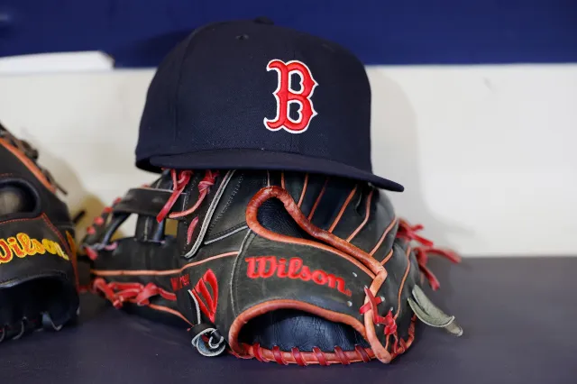 MILWAUKEE, WISCONSIN - MAY 27: A picture of the Boston Red Sox hat and a Wilson glove before the game against the Milwaukee Brewers at American Family Field on May 27, 2025 in Milwaukee, Wisconsin. (Photo by John Fisher/Getty Images)