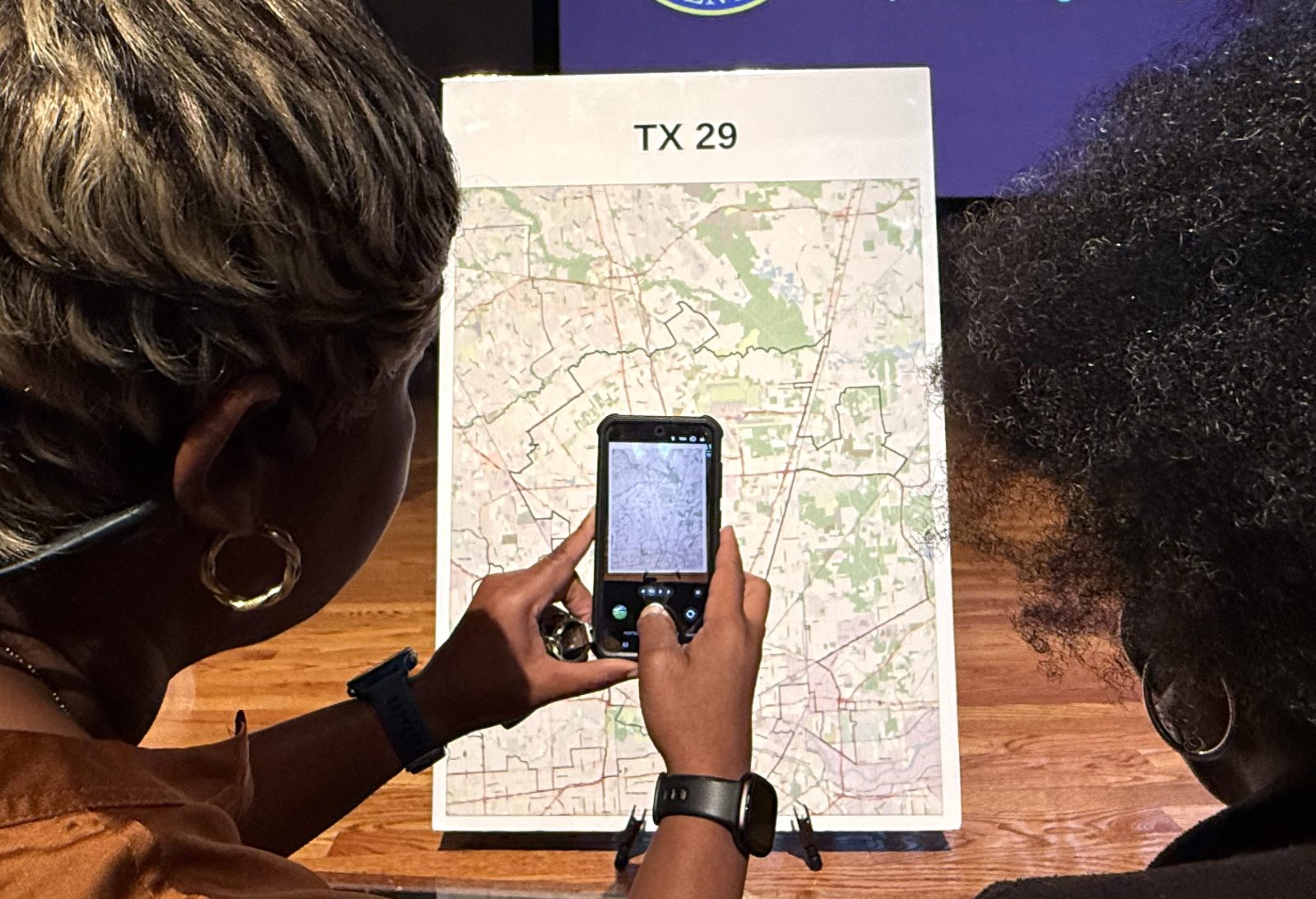 Voters look at a map to understand the new redistricting maps approved by Texas lawmakers for the 2026 midterm elections, at San Jacinto College in Houston, Texas, on August 27, 2025. 
