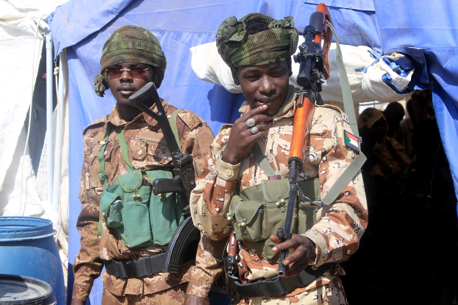 Security stand by during a visit by the Darfur Regional Governor and leader of the Sudan Liberation Movement (SLM)at the Al-Afad camp for displaced people in the town of Al-Dabba, northern Sudan, on November 26, 2025.