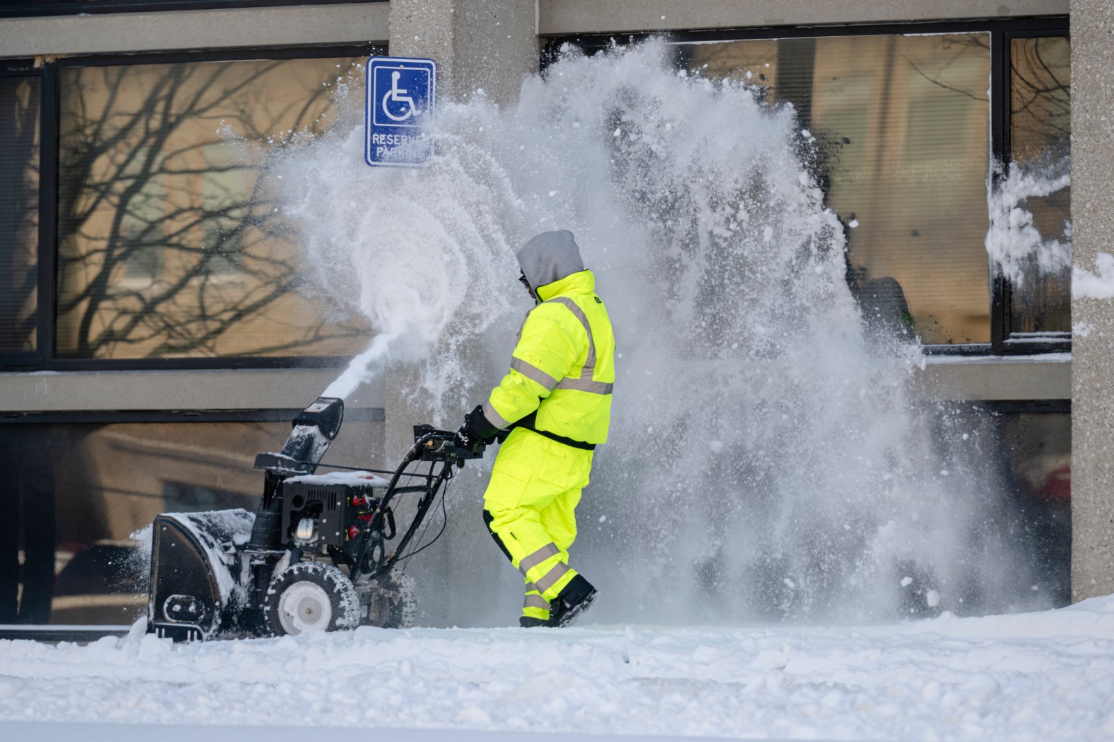 A contractor uses a snowblower in front of a business following a major snow storm on January 26, 2026, in Louisville, Kentucky.
