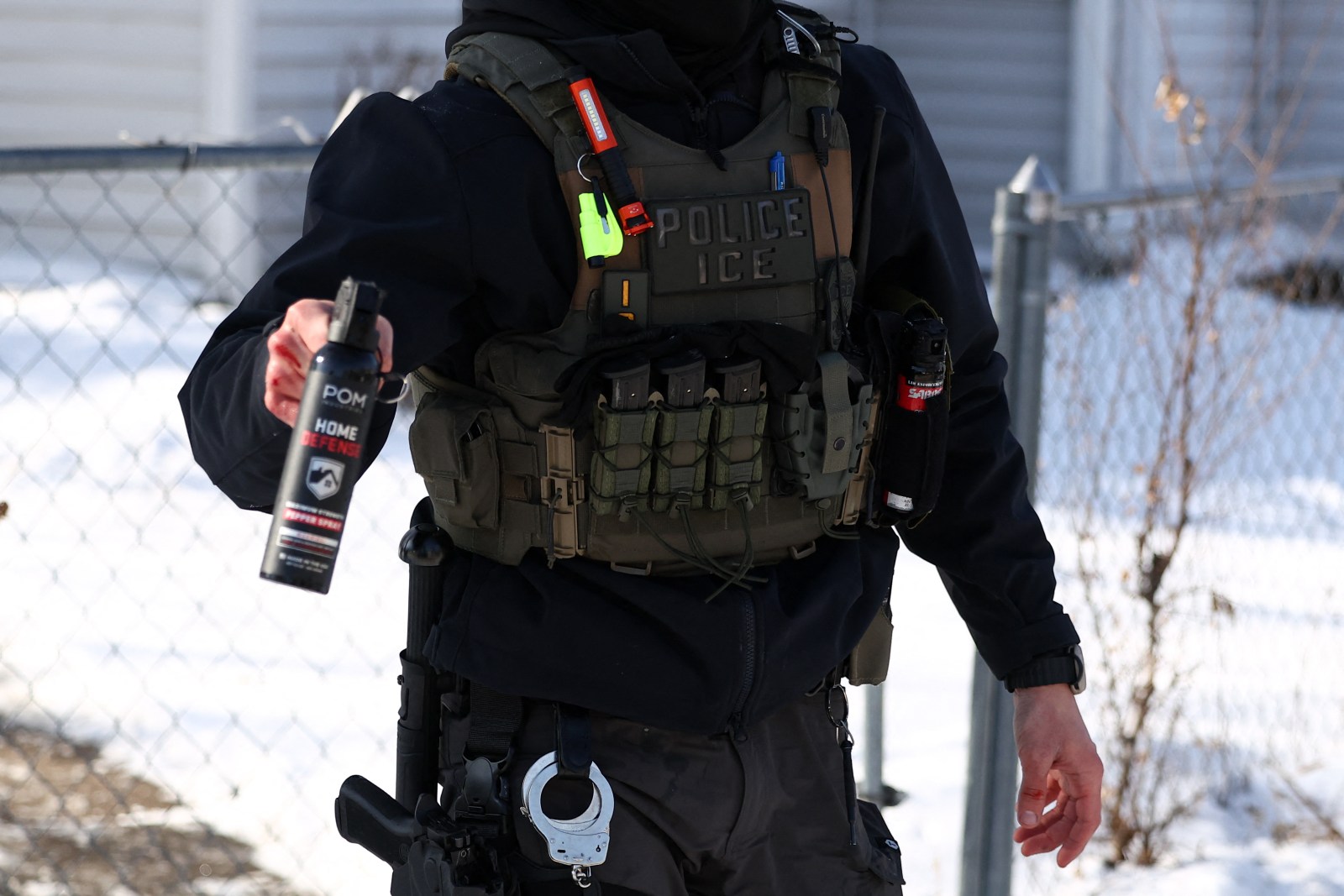 A federal agent aims his pepper spray gun during an anti-immigration raid in Minneapolis, Minnesota on February 3, 2026.