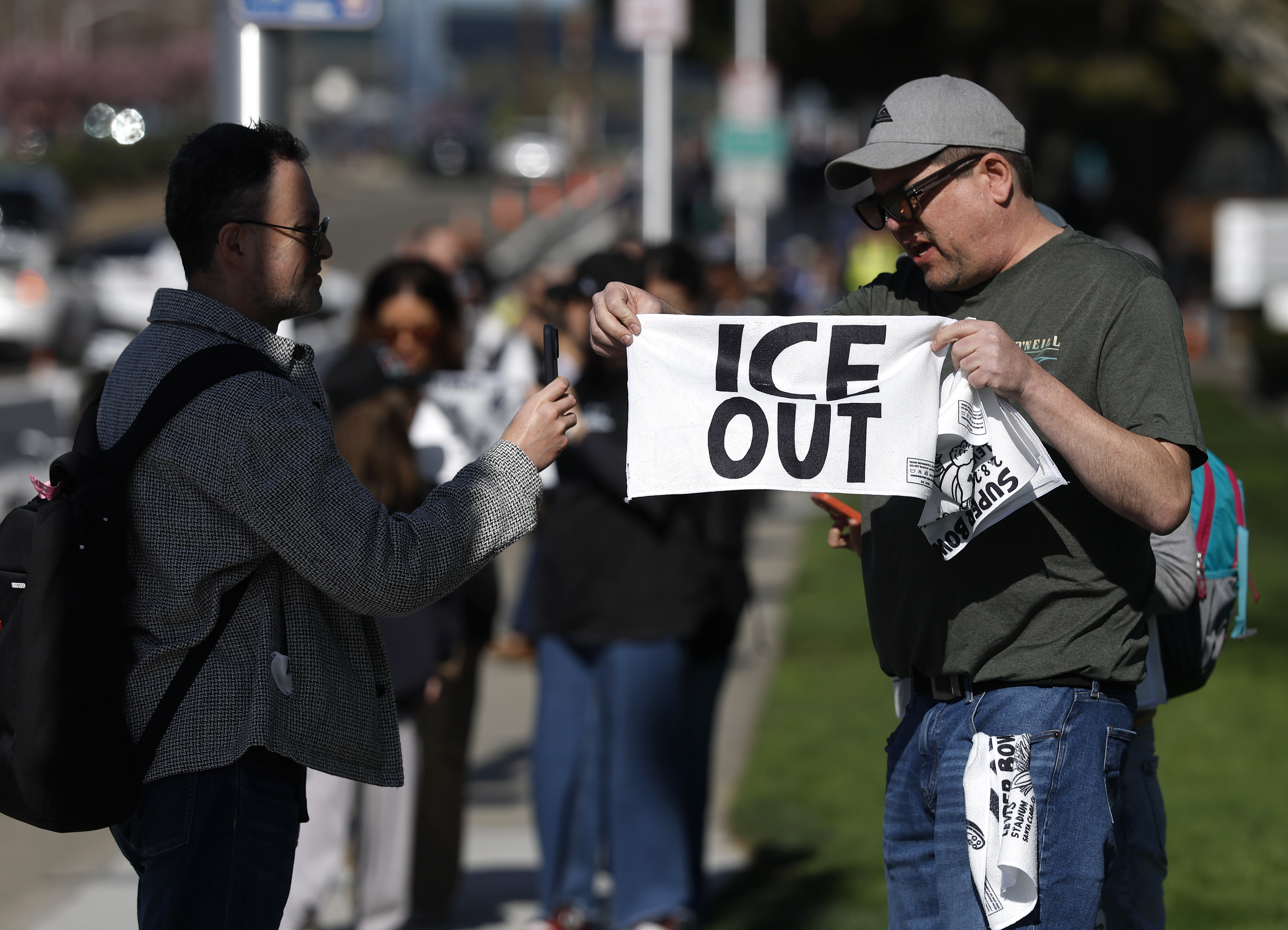 Activists Hand Out ‘ICE OUT’ Towels at Super Bowl LX
