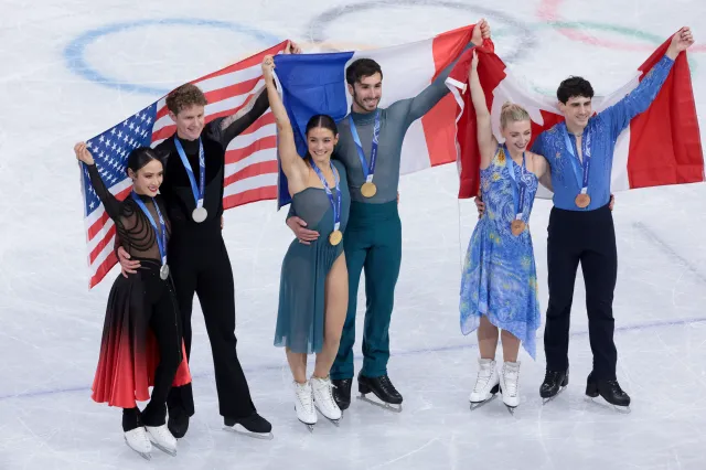 MILAN, ITALY - FEBRUARY 11: From left, Silver medalists Madison Chock and Evan Bates of United States, Gold medalists Laurence Fournier Beaudry and Guillaume Cizeron of France, Bronze medalists Piper Gilles and Paul Poirier of Canada during the victory ceremony of the Figure Skating Ice Dance event on day five of the Milano Cortina 2026 Winter Olympic Games at Milano Ice Skating Arena on February 11, 2026 in Milan, Italy. (Photo by Jean Catuffe/Getty Images)