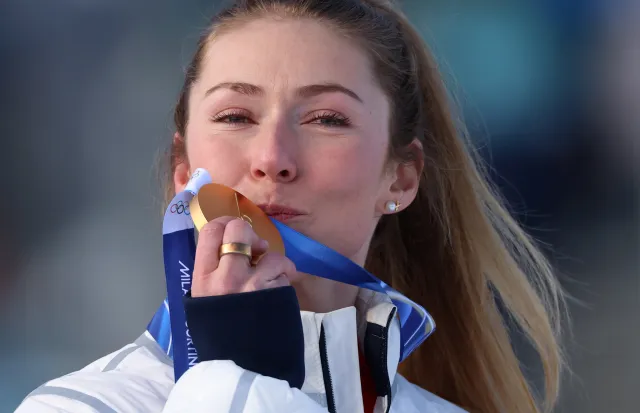 Gold medalist Mikaela Shiffrin of Team United States kisses her medal on the podium during the medal ceremony following the Women's Slalom Run on day twelve of the Milano Cortina 2026 Winter Olympics at Tofane Alpine Skiing Centre on February 18, 2026 in Cortina d'Ampezzo, Italy.