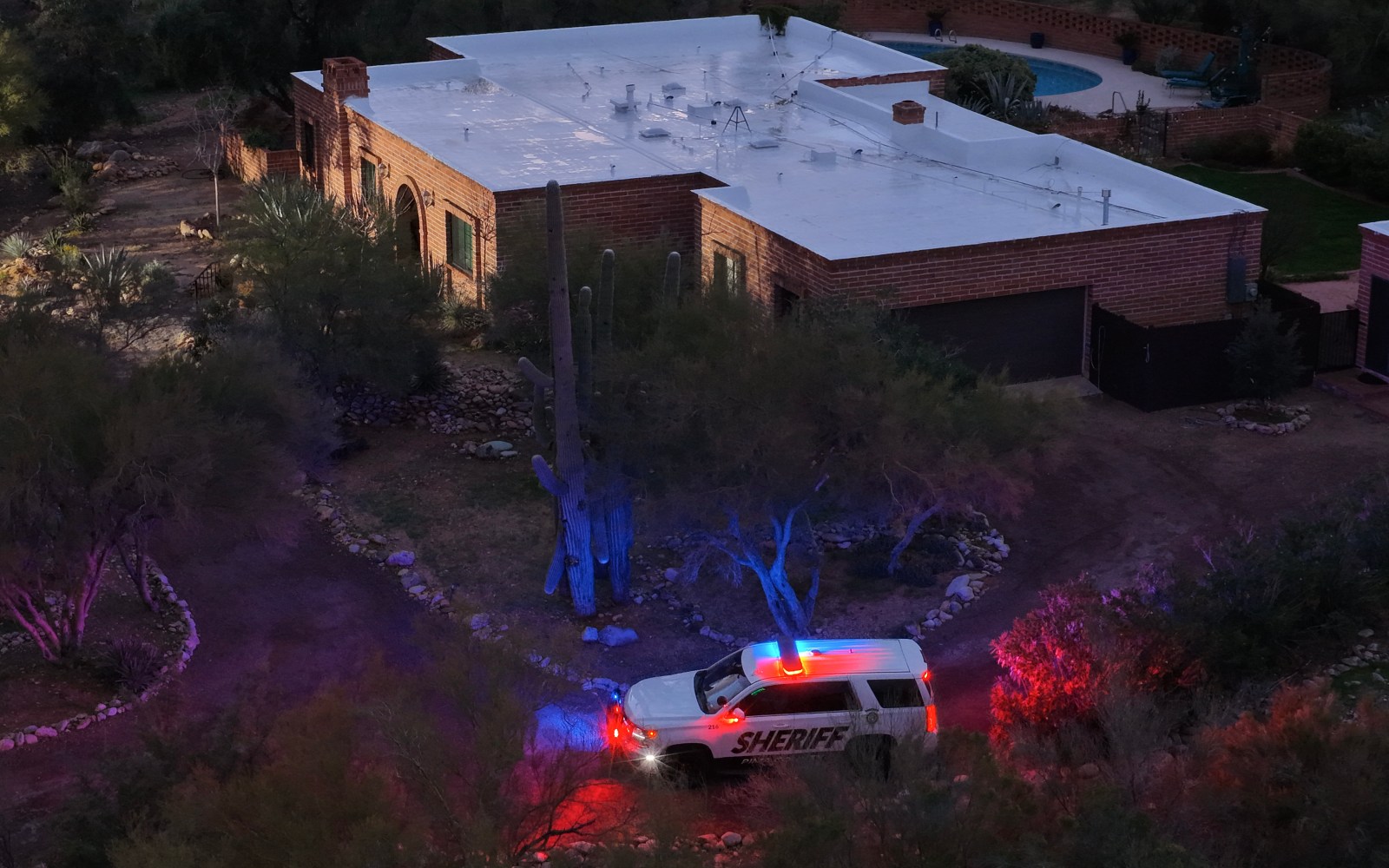 TUCSON, ARIZONA – FEBRUARY 19: In an aerial view, a Pima County Sheriff’s vehicle sits with its lights on in the driveway of the home of Nancy Guthrie on February 19, 2026, in Tucson, Arizona. Law enforcement officials continue to search for Nancy Guthrie, the 84-year-old mother of U.S. journalist and television host Savannah Guthrie, after she went missing from her home on the morning of February 1st. An anonymous donor contributed $100,000 to the total reward offered in the Nancy Guthrie case, bringing it to over $200,000. (Photo by Joe Raedle/Getty Images)