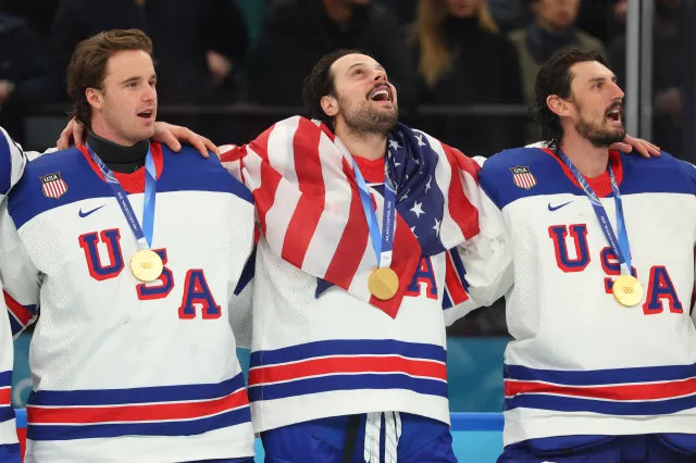 The United States team reacts to the national anthem after winning gold.