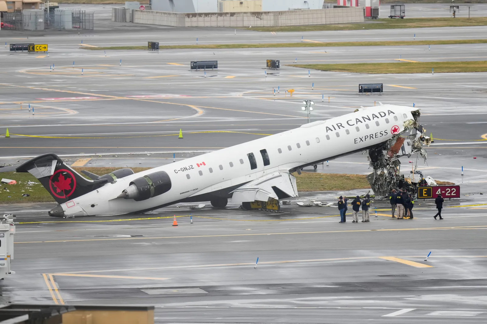 Image for article: Flight Attendant Thrown, Still Strapped in Seat Survives LaGuardia Crash