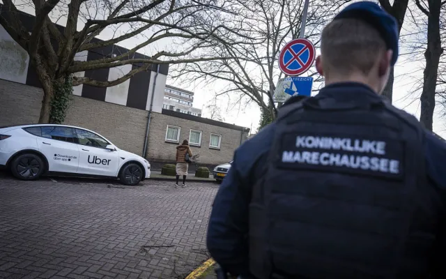 A military police force member of Royal Netherlands Marechaussee stands guard near a Jewish school in Amsterdam on March 16, 2026, following its reopening, two days after an attack on the Jewish institution.