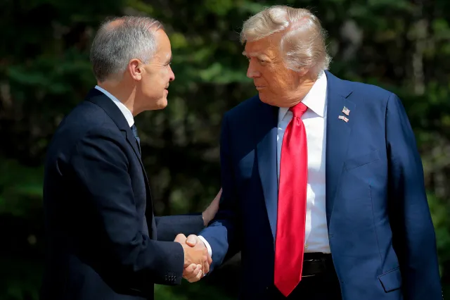 Canadian Prime Minister Mark Carney greets U.S. President Donald Trump at the official welcome ceremony during the G7 Leaders' Summit on June 16, 2025 in Kananaskis, Alberta.