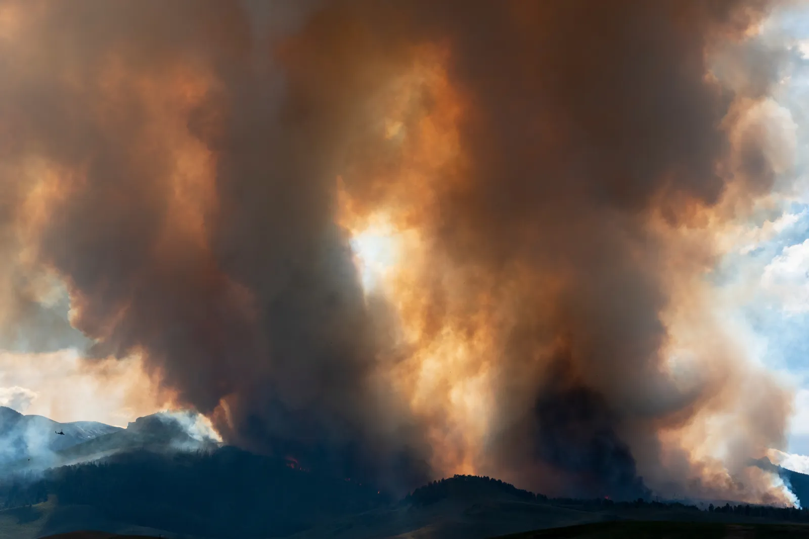 File image: Smoke billows and flames rise from the Lowline fire on July 26, 2023, near Gunnison, Colorado.