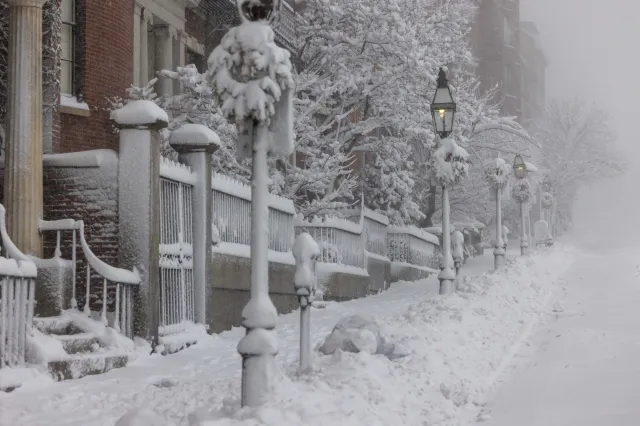 Snow covers Beacon Street near the Massachusetts State House on February 23, 2026 in Boston, Massachusetts