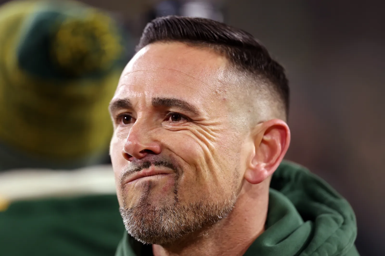 Head coach Matt LaFleur of the Green Bay Packers walks across the field before the game against the Baltimore Ravens.