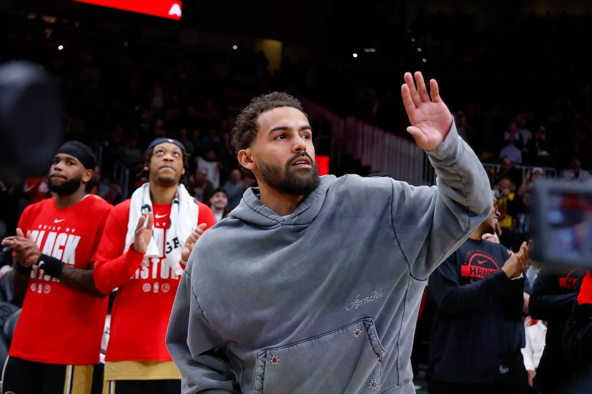 Washington Wizards guard Trae Young waves to crowd at Atlanta Hawks game