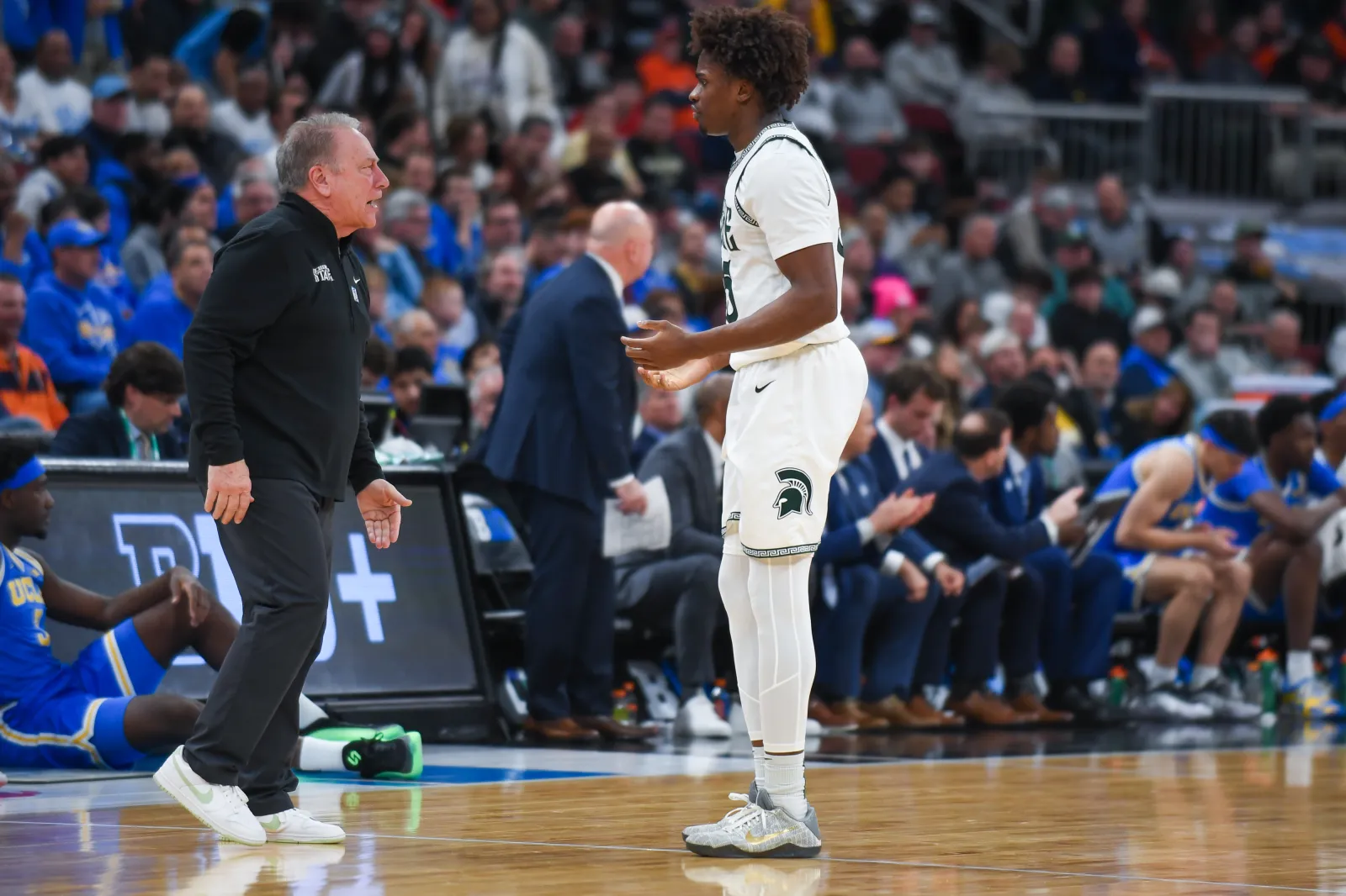 Head Basketball Coach Tom Izzo talks with Coen Carr #55 of the Michigan State Spartans during the first half of a Big Ten Men's Basketball Tournament Quarterfinals game against the UCLA Bruins at the United Center on March 13, 2026 in Chicago, Illinois. The UCLA Bruins won the game 88-84.