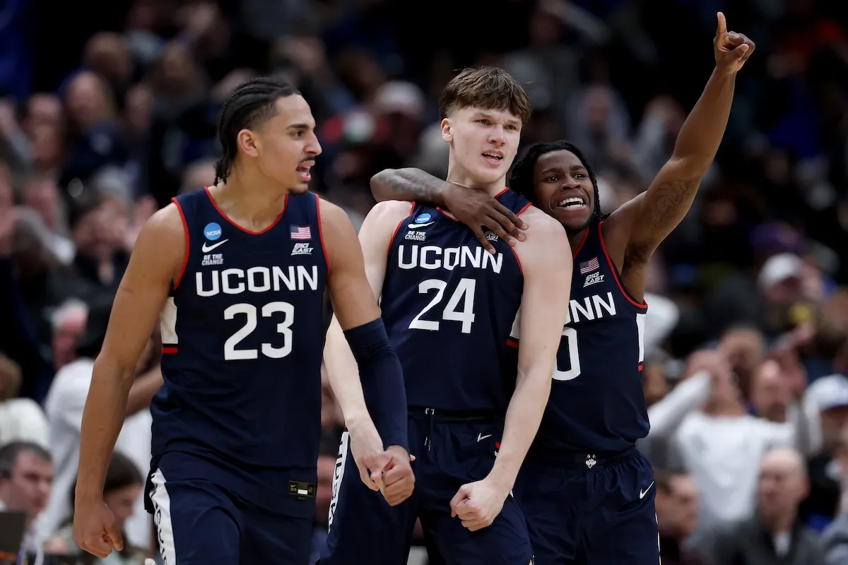 UConn Huskies players Jayden Ross Braylon Mullins and Malachi Smith celebrate after game-winning shot