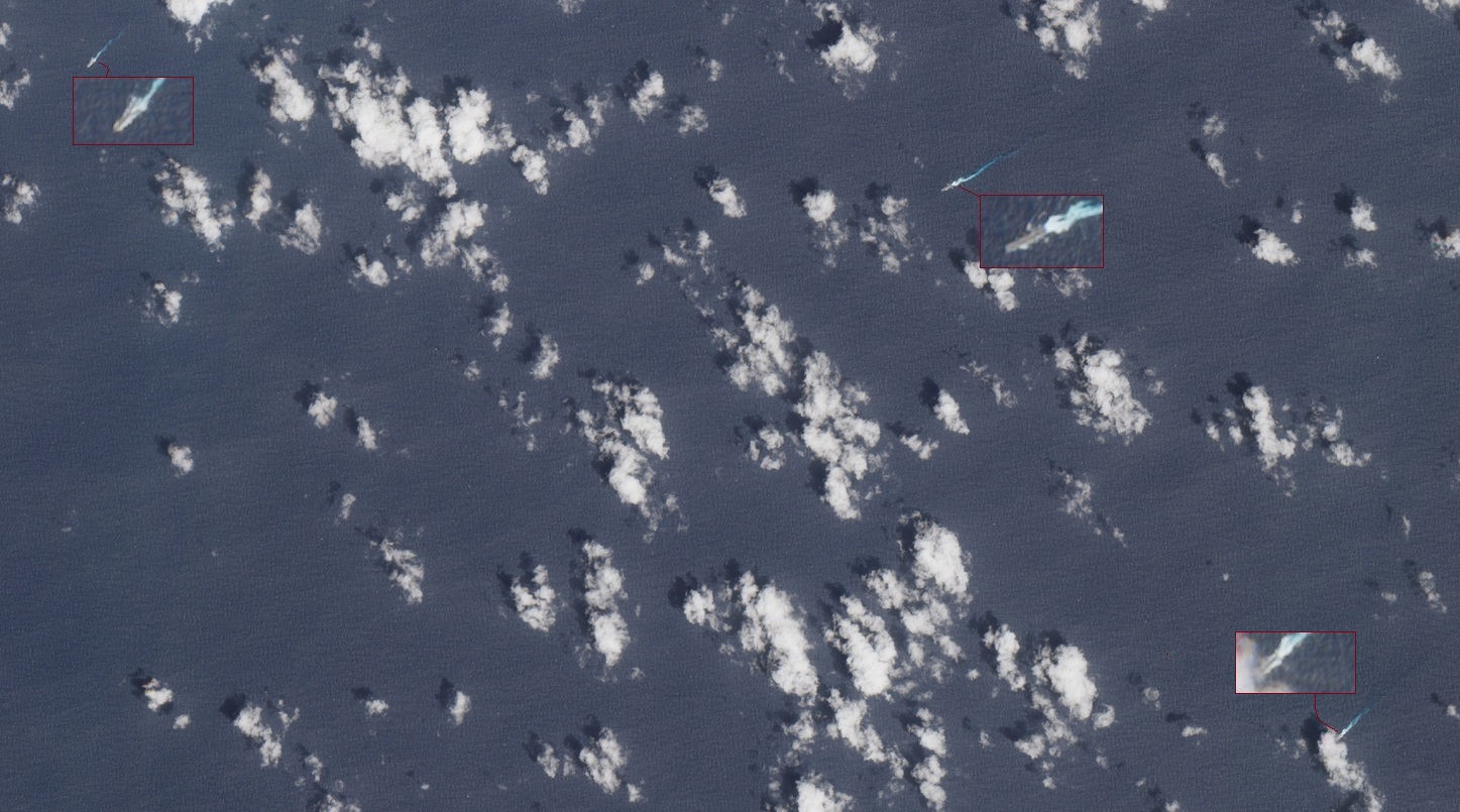 Satellite image of the USS Tripoli amphibious assault ship and escort destroyers transiting at high speed en route to the Middle East March 2026