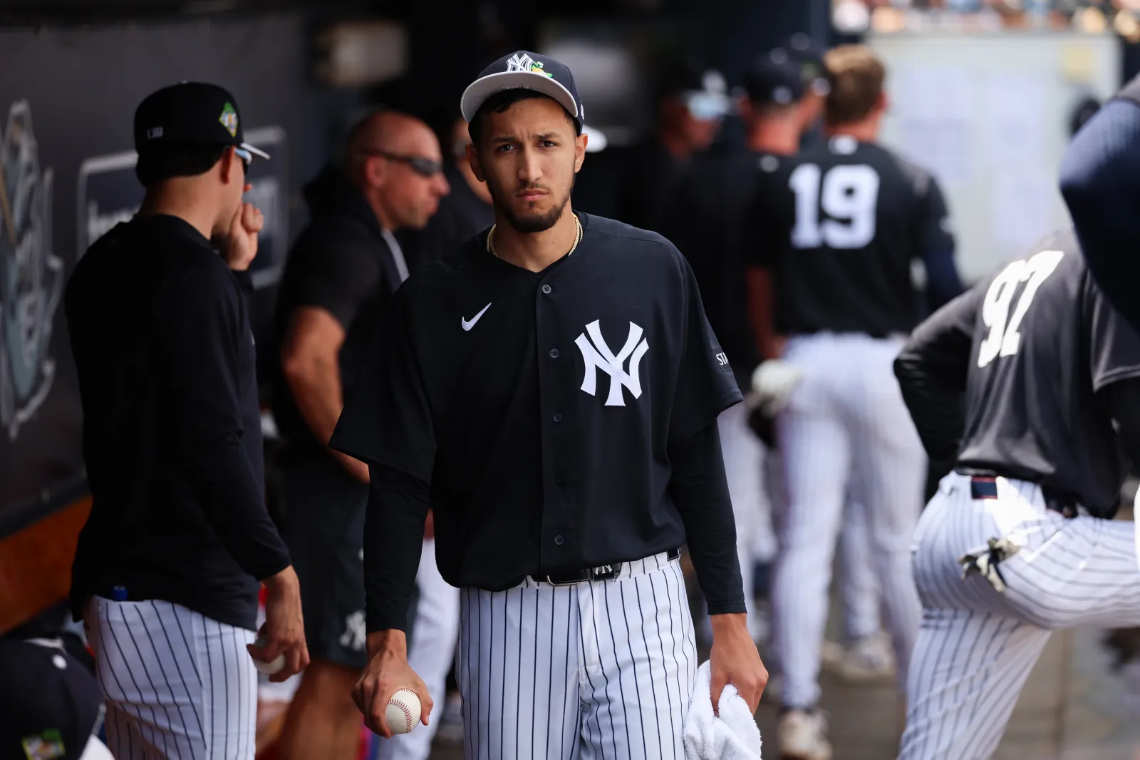 Yankees pitcher Elmer Rodriguez watches from the dugout.