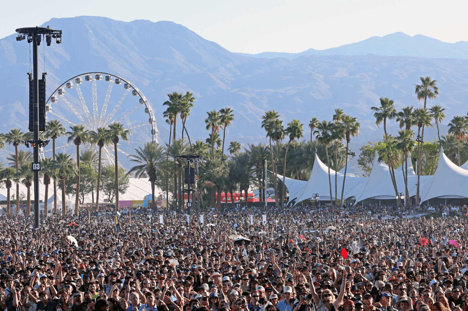 Retirees Greet Coachella Festival Attendees with Signs Near Entrance in Indio