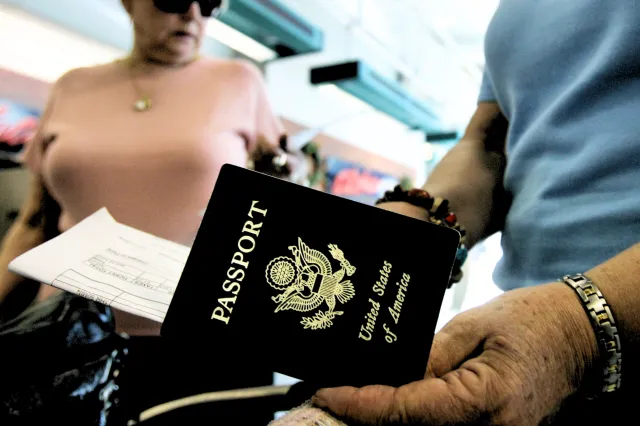 File image: Travelers take out their passports before checking in at San Diego International Airport January 8, 2006 in San Diego, California.