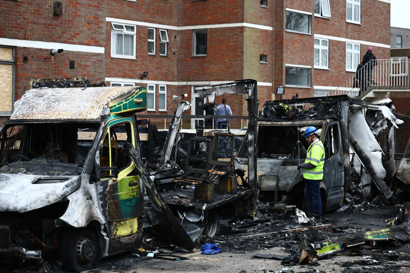 An official works among the burnt out ambulances at the scene of an antisemitic arson attack in the Golders Green neighbourhood of north London, on March 24, 2026.