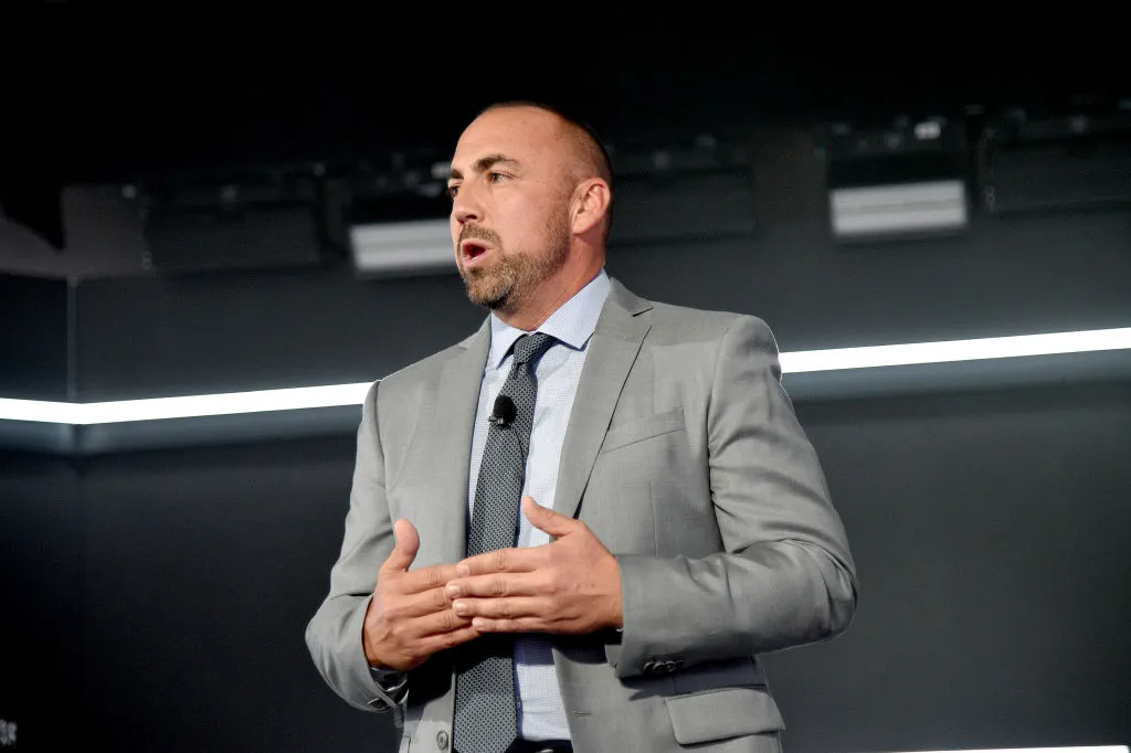 Left: Donald Trump's social media platform Truth Social is shown on a cell phone on March 25, 2024 in Chicago, Illinois, right: Kevin McGurn speaks onstage during Vevo's 10-Year Anniversary Event on October 16, 2019 in New York City.