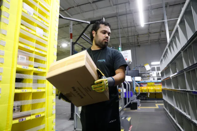 TAMPA, FLORIDA - NOVEMBER 27: Amazon associate Luis Colon works to ship out same day orders during Cyber Monday at the Same-Day Delivery Facility Fulfillment Center on November 27, 2023 in Tampa, Florida. Dedicated to online shopping, Cyber Monday is one of Amazon's busiest days following Thanksgiving, marked by retailers providing substantial discounts and promotions.