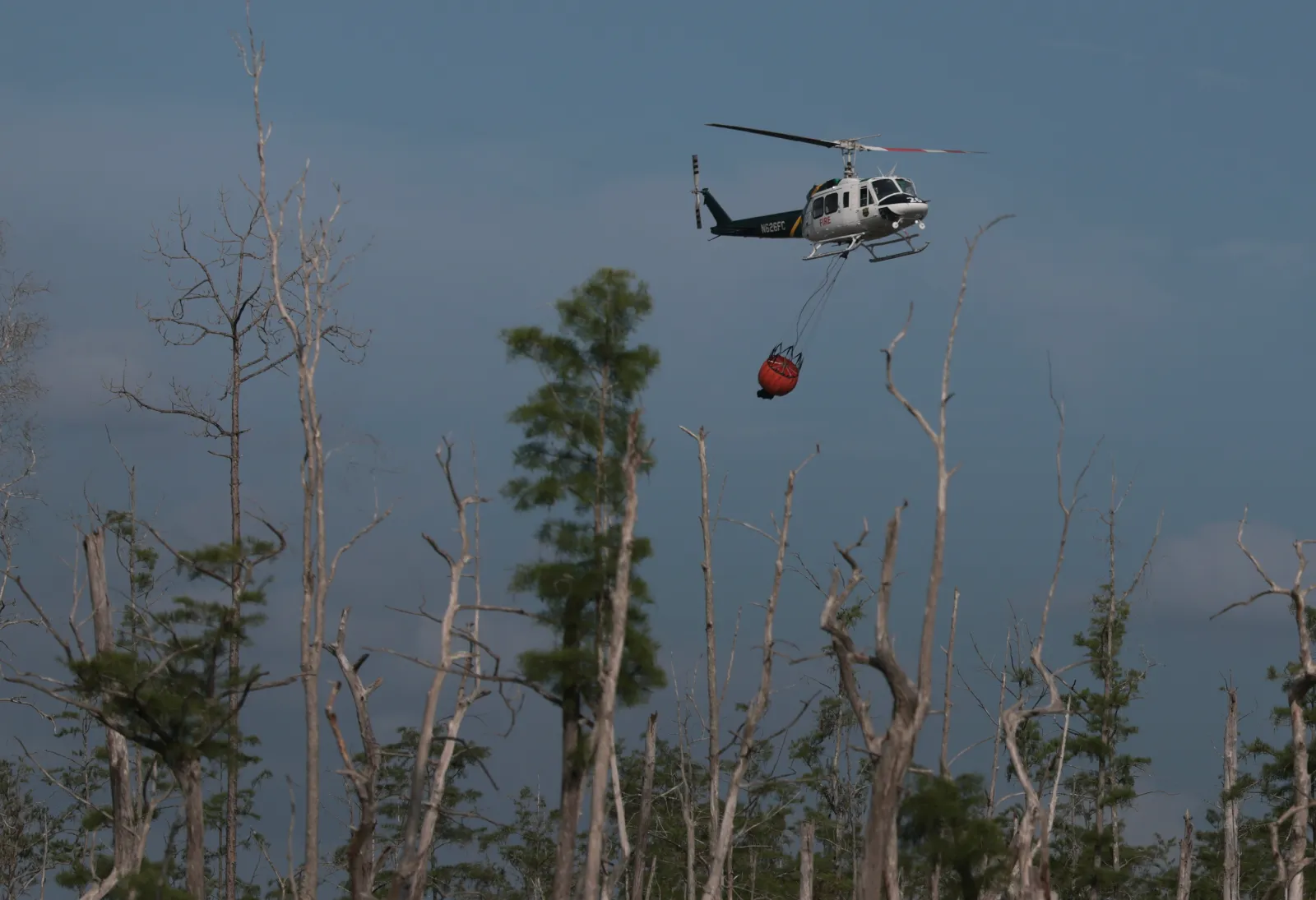 A Florida Forest Service helicopter combats a wildfire.