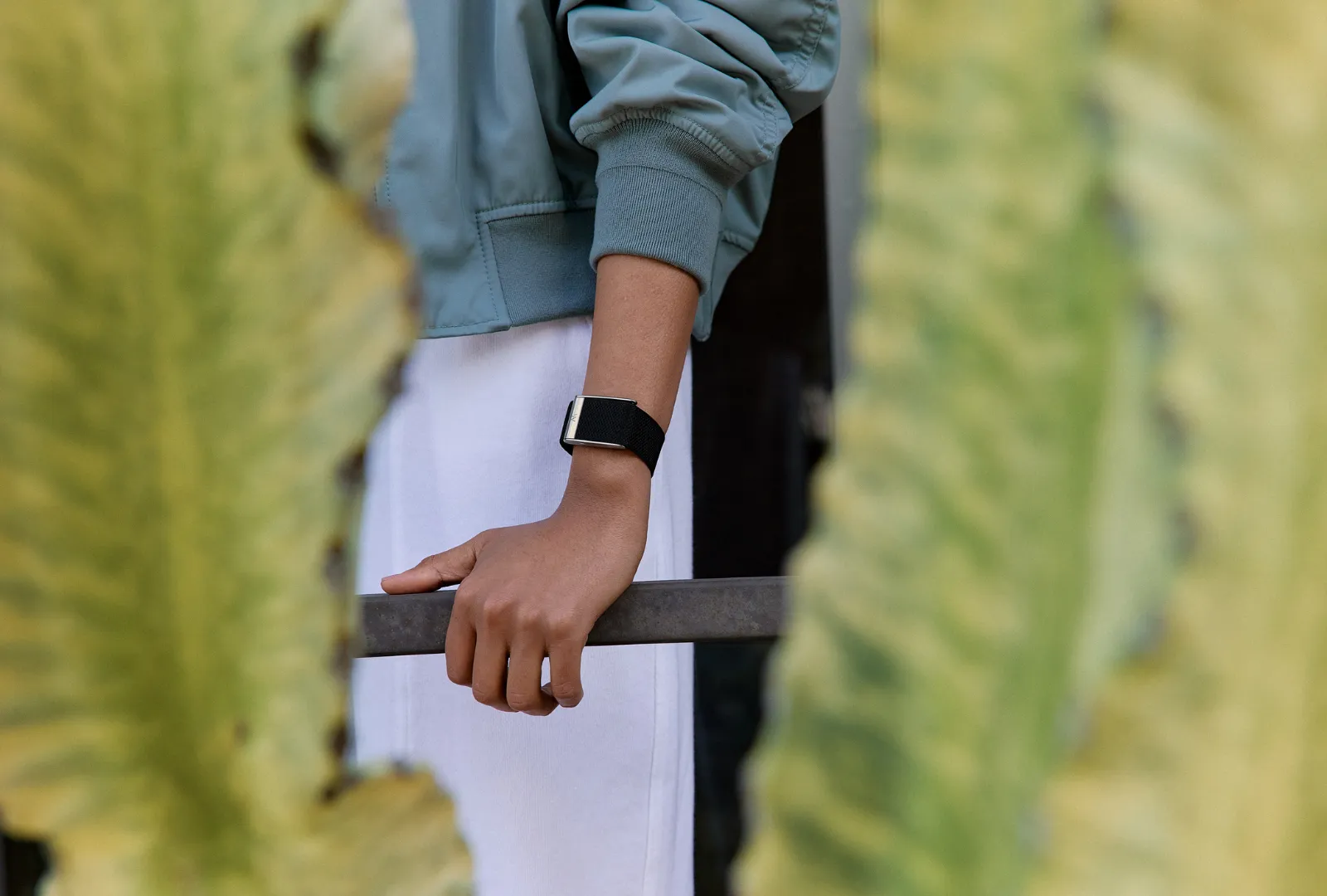A woman wears a WHOOP band on her left wrist.