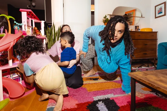 The family plays together on the floor.