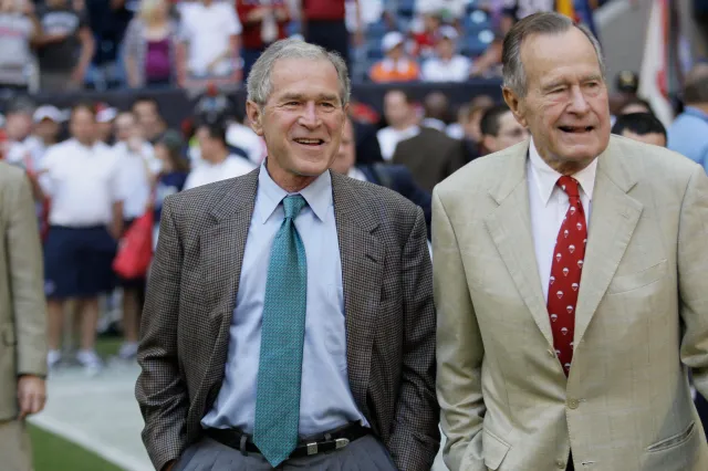 Former Presidents George H. W. Bush, right, and George W. Bush before the Houston Texans NFL game against the San Francisco 49ers on October 25, 2009, in Houston. (AP Photo/David J. Phillip)
