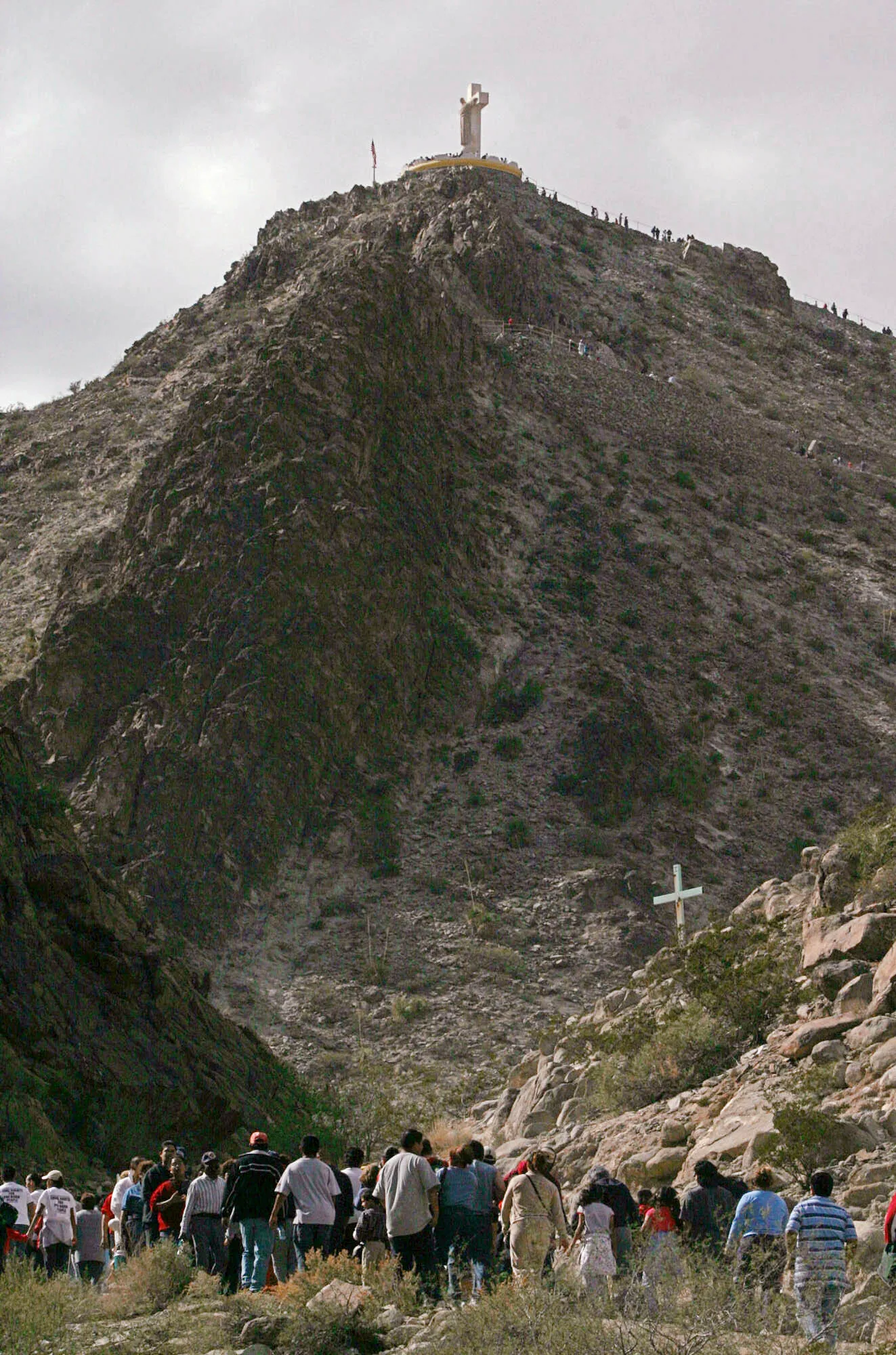 In this Oct. 31, 2004, file photo, people from El Paso, Texas, Ciudad Juarez, Mexico, and Las Cruces, N.M., walk the trail to the base of the statue to pray during the annual October pilgrimage up Mount Cristo Rey in Sunland Park, N.M. (AP Photo/J.R. Hernandez, File)