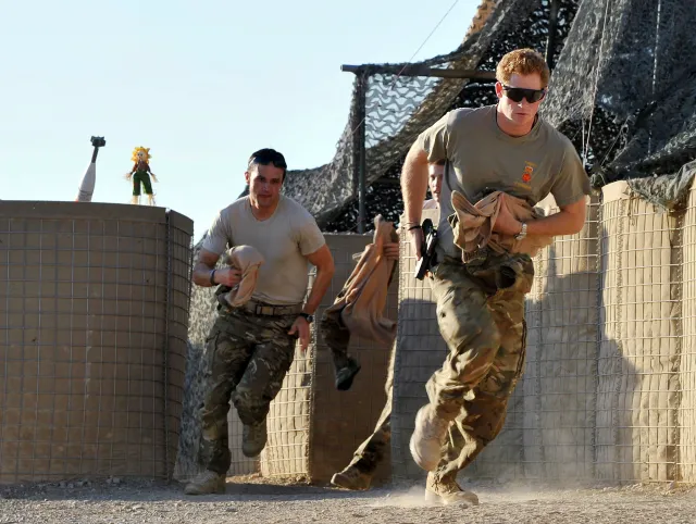 File photo: Prince Harry, right, races to his Apache helicopter at the British-controlled flight-line in Camp Bastion in southern Afghanistan on November 3, 2012.