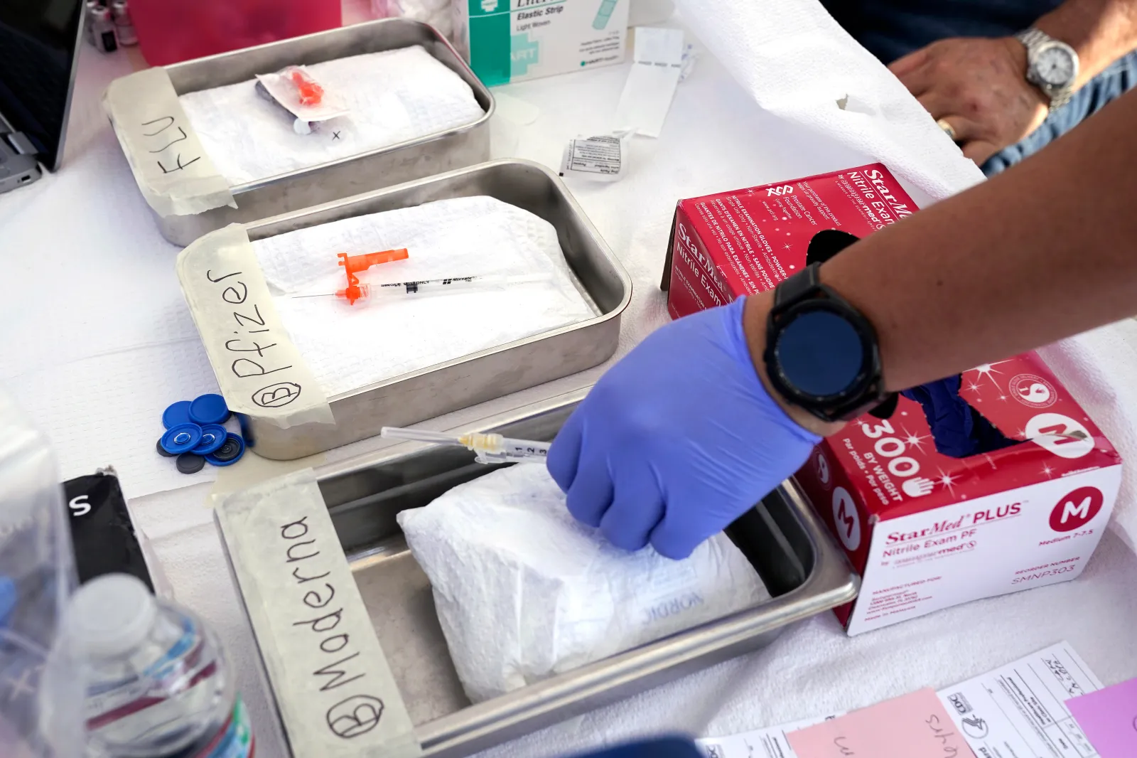 Syringes with vaccines are prepared at the L.A. Care and Blue Shield of California Promise Health Plans' Community Resource Center, where they were offering members and the public free flu and COVID-19 vaccines on October 28, 2022, in Lynwood, California.