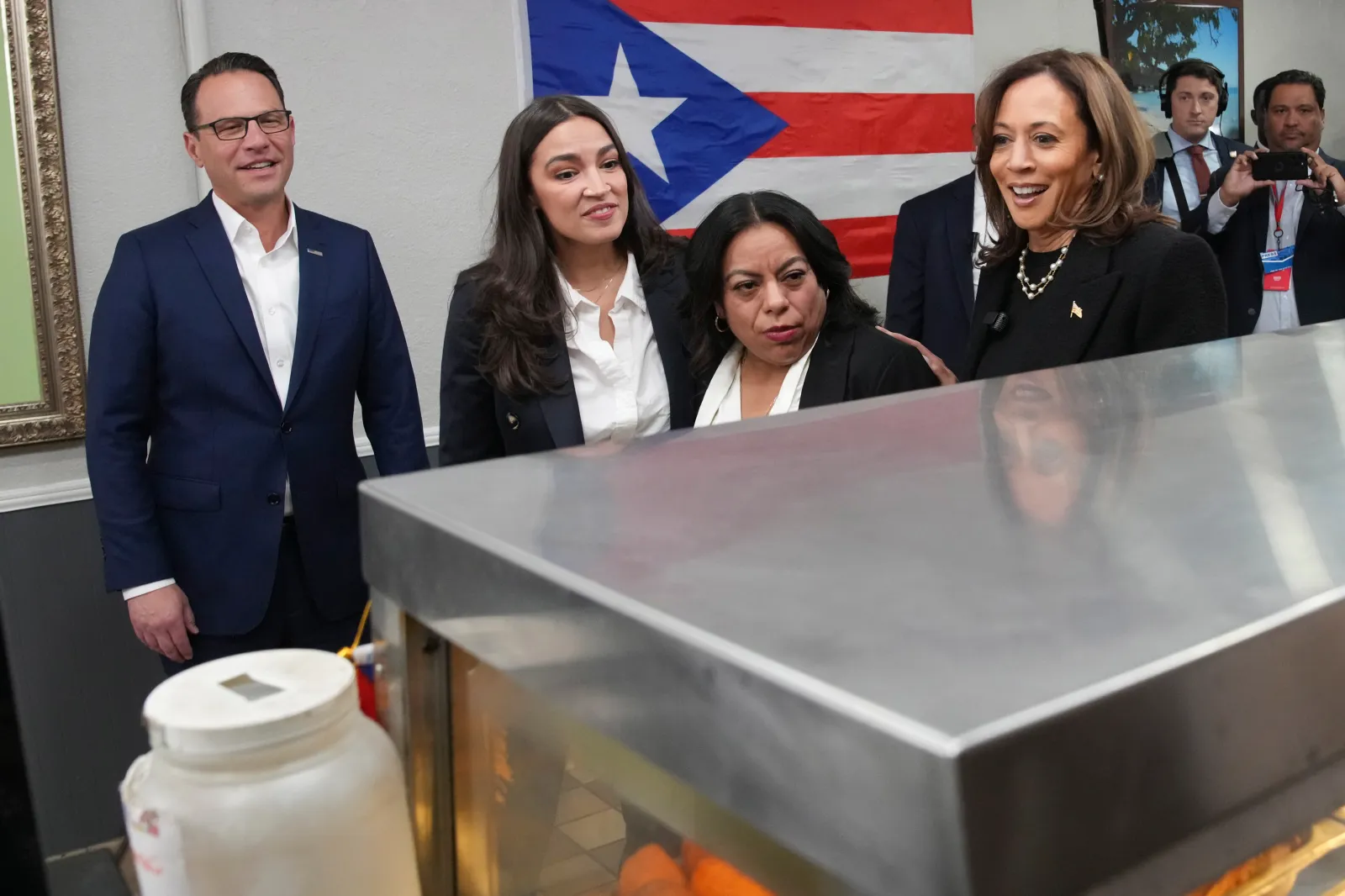 Then-Democratic presidential nominee Vice President Kamala Harris is seen with Representative Alexandria Ocasio-Cortez of New York, and Pennsylvania Governor Josh Shapiro during a campaign stop in Reading, Pennsylvania, on November 4, 2024. (AP Photo/Jacquelyn Martin)