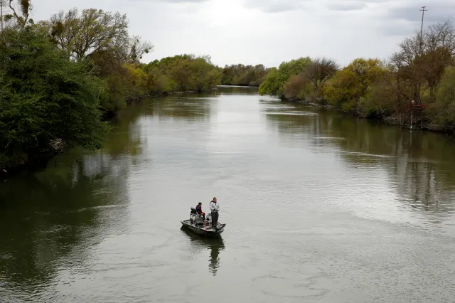 People fish in the Sacramento-San Joaquin River Delta's Elk Slough near Courtland, California, in 2020.