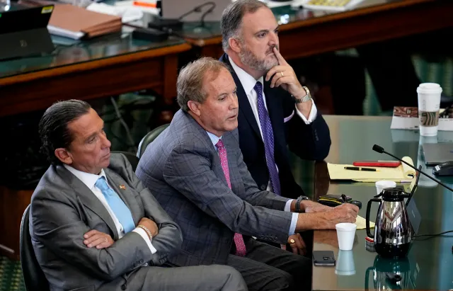 Texas Attorney General Ken Paxton, center, sits with his attorneys at his impeachment trial at the Texas Capitol on September 15, 2023.