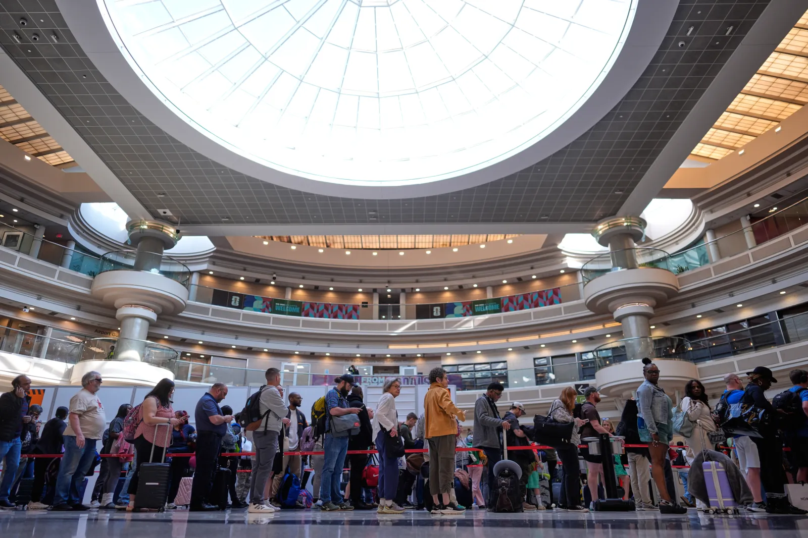 People wait in a TSA line at the Hartsfield-Jackson Atlanta International Airport on March 23 in Atlanta. (AP Photo/Mike Stewart)