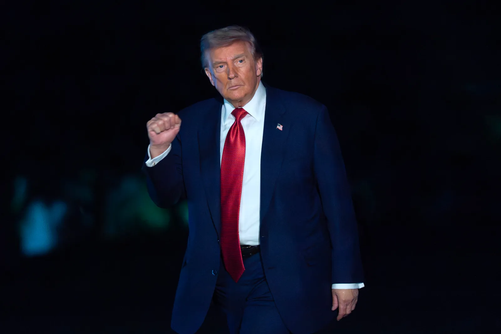 President Donald Trump waves to reporters as he walks on the South Lawn upon his arrival to the White House on May 8 in Washington, DC. (AP Photo/Jose Luis Magana)