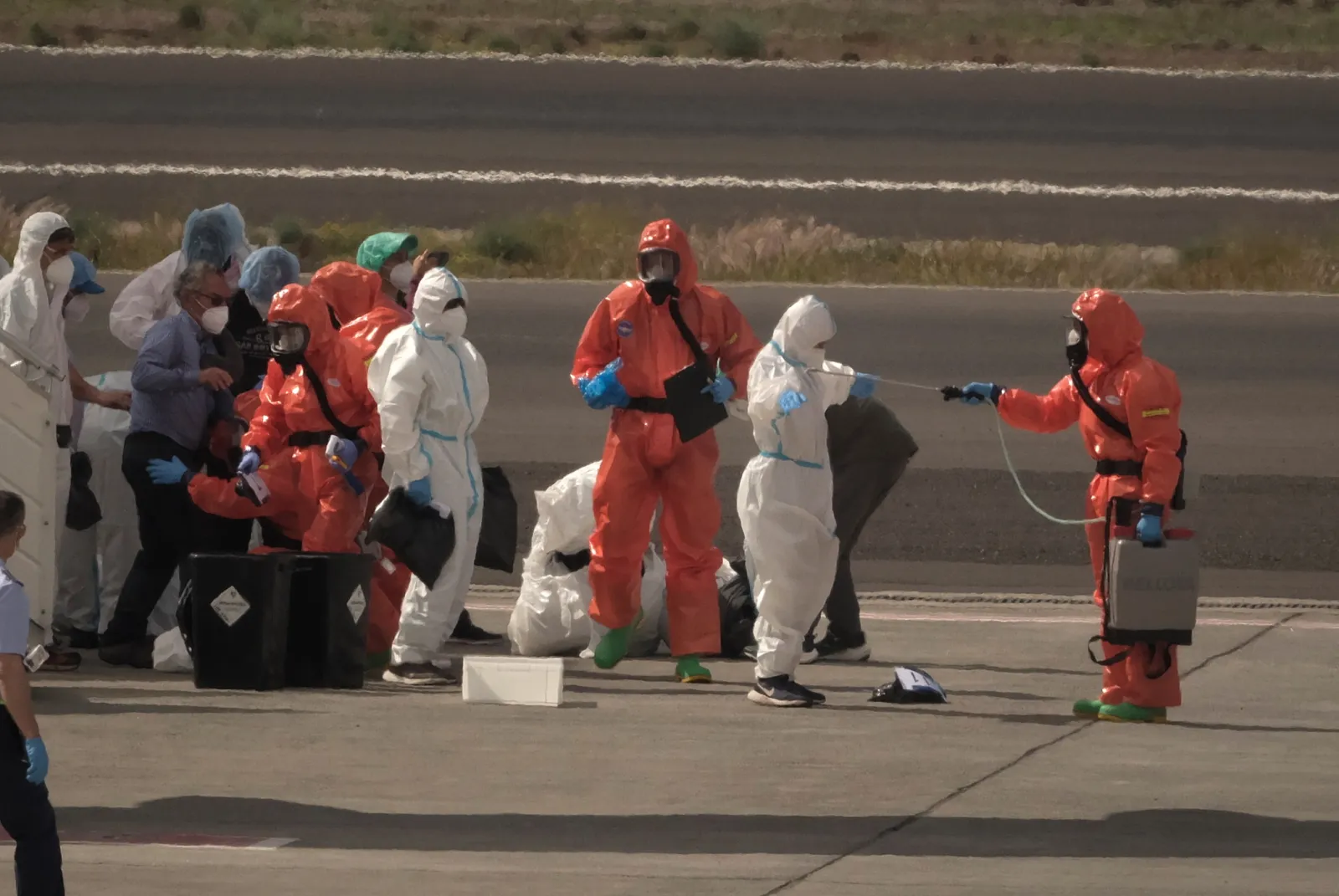 Passengers are sprayed with disinfectant after disembarking from the hantavirus-stricken cruise ship MV Hondius in Tenerife on May 10.