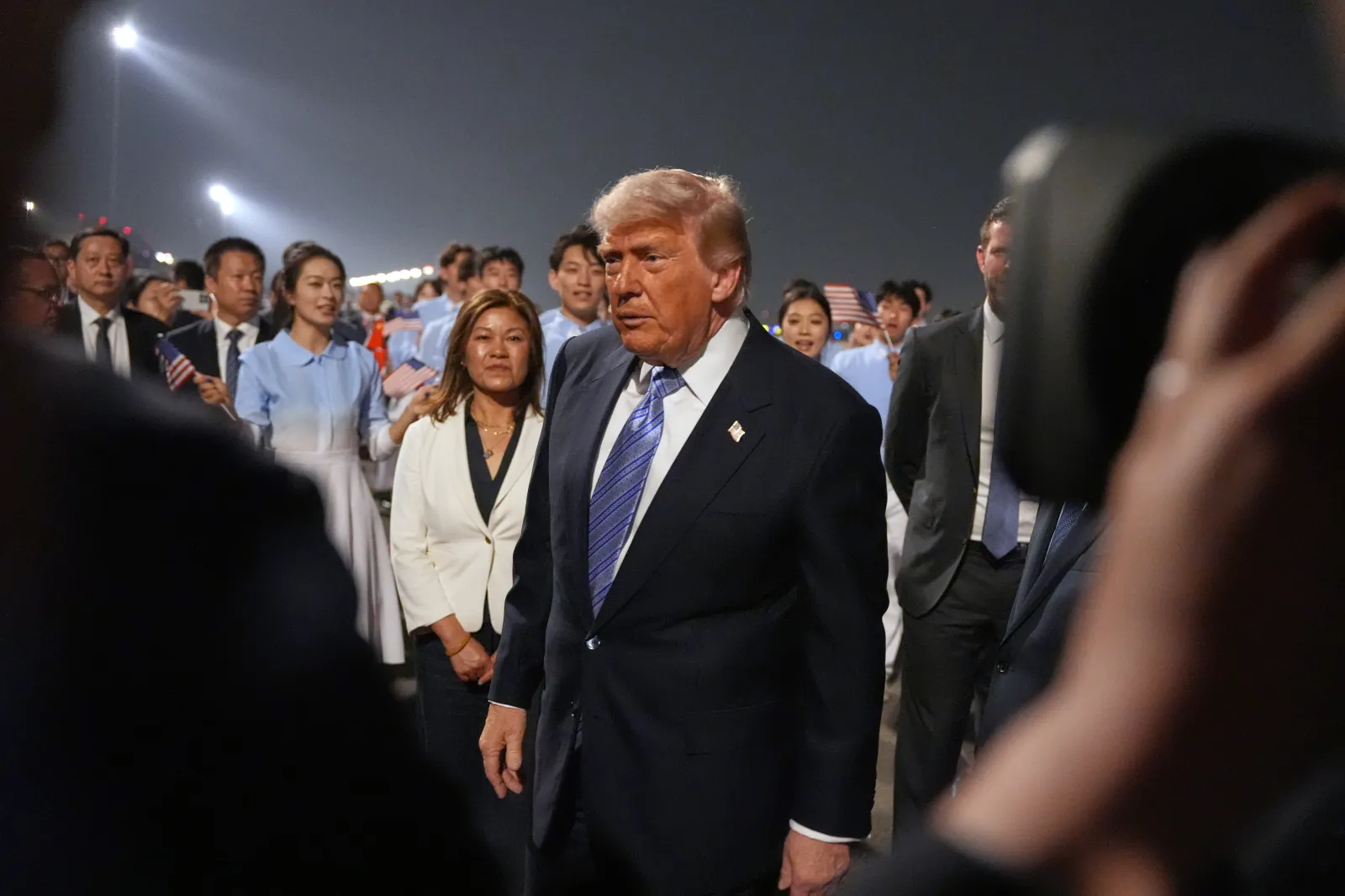 President Donald Trump walks during a welcome ceremony as he arrives on Air Force One on May 13, 2026, at Beijing Capital International Airport in China.