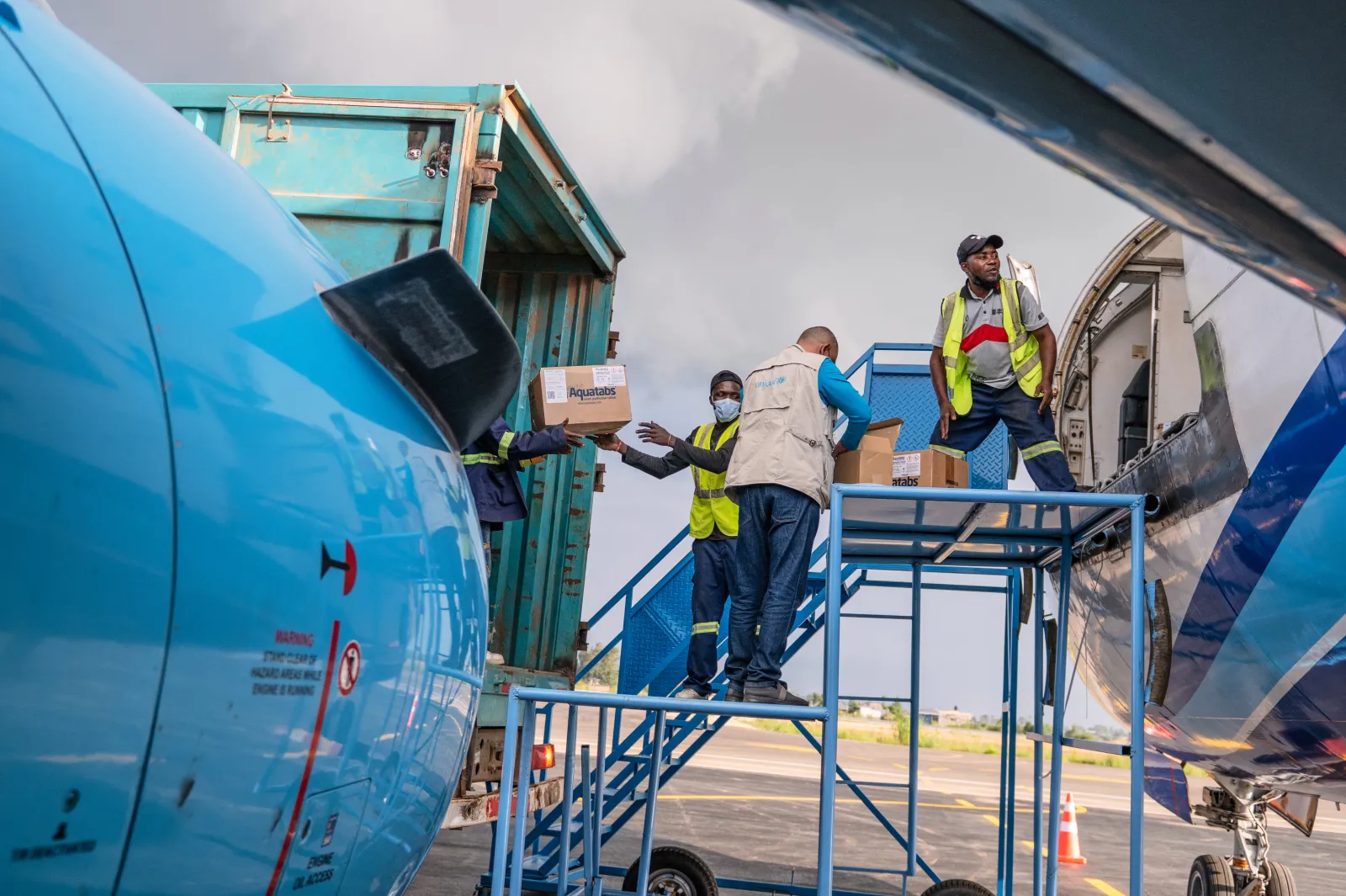 Workers offload a shipment of more than 15 tons of supplies donated by UNICEF as part of the response to the Ebola virus outbreak, at Bunia National Airport in Bunia, Congo, on Tuesday. (AP Photo/Moses Sawasawa)