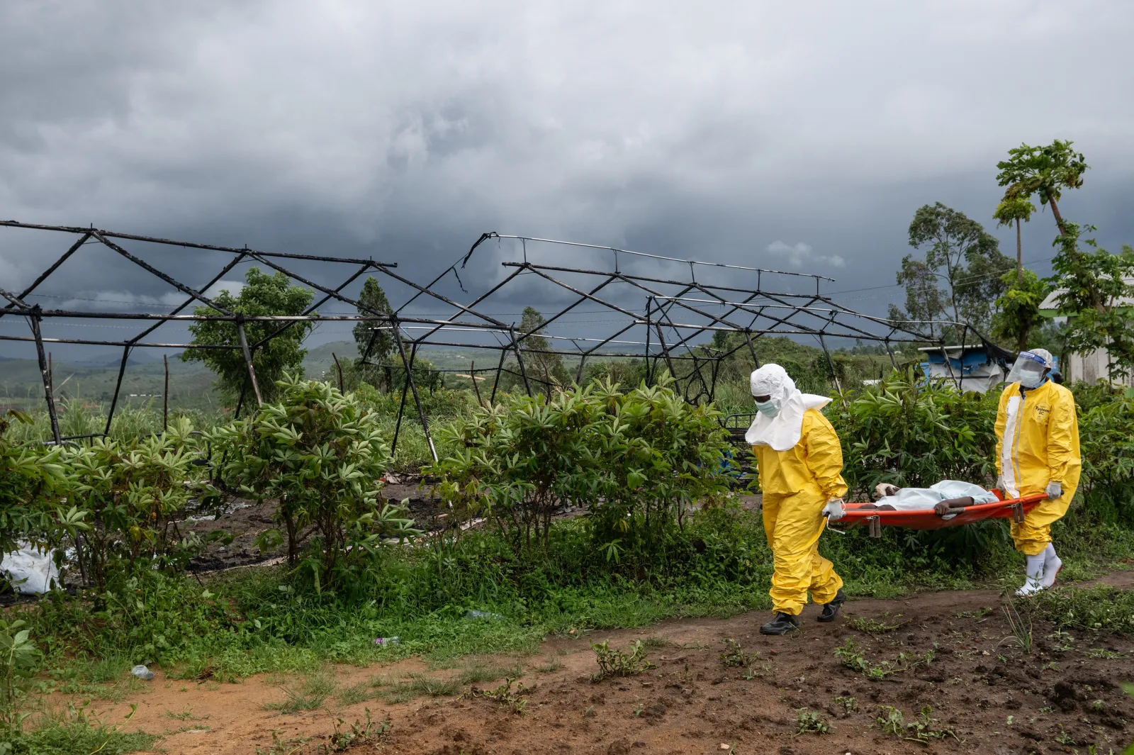 Medical staff carry an Ebola patient to a treatment center in Rwampara, Congo, on May 21. (AP Photo/Moses Sawasawa)